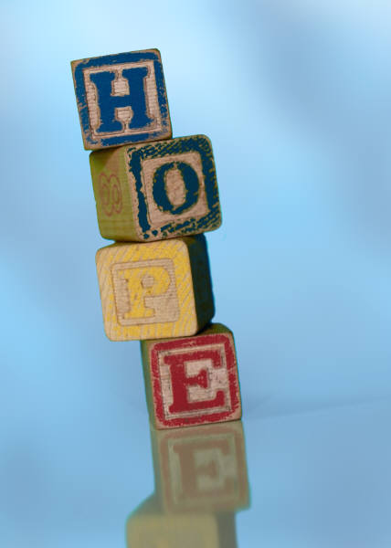Stack of wooden building blocks spelling HOPE